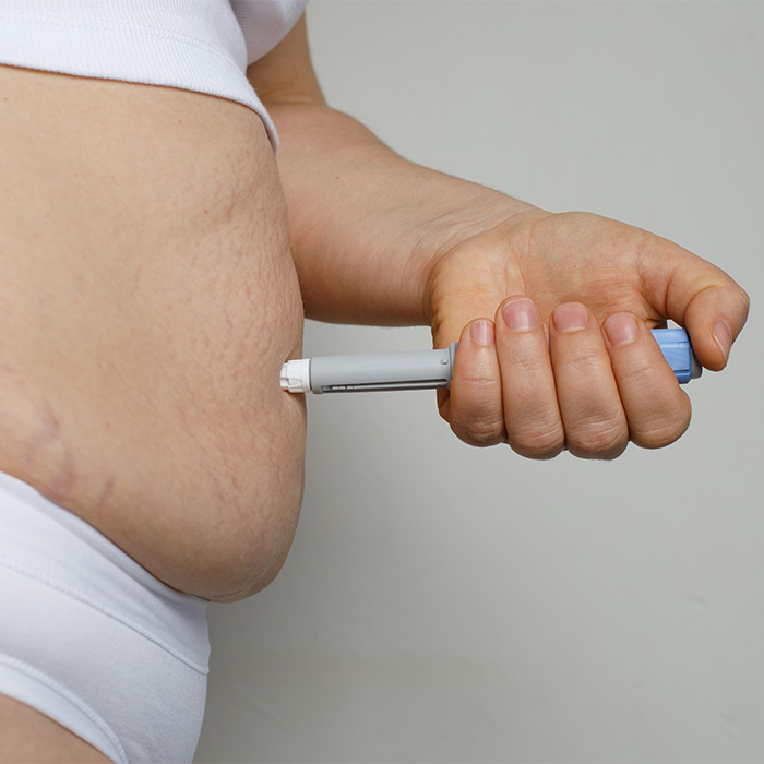 A person administering an injection, related to cosmetic procedure risks. A person administering an injection, related to cosmetic procedure risks.