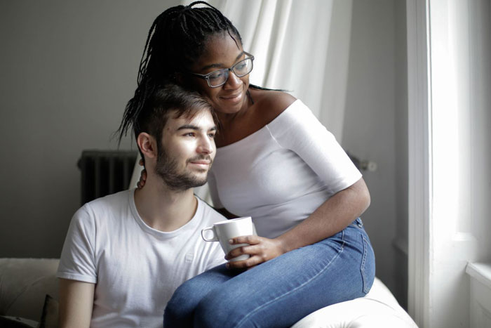 A woman and man looking happy and in love at home. The woman refuses to eat at MIL's home.