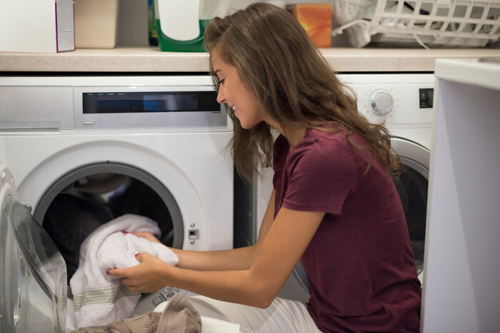 A woman doing laundry. Gynecologists advise women to maintain good hygiene for health.