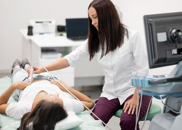 A gynecologist performs an ultrasound on a woman, providing essential advice for women's health and wellness.