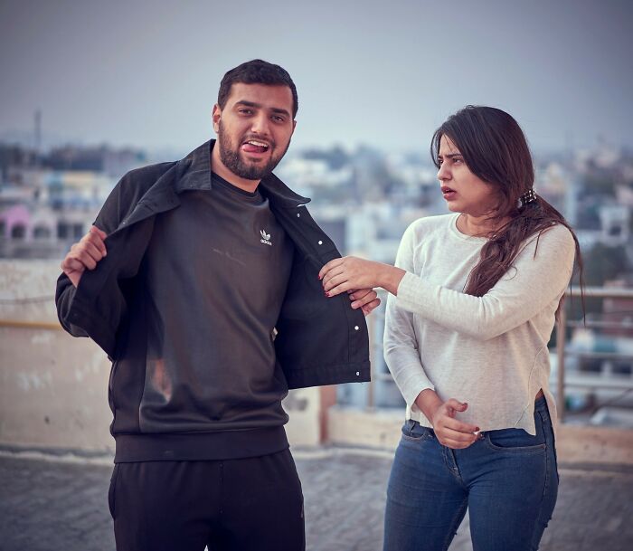 A man with an open jacket gestures, while a woman looks disgusted, showing potential first date red flags.