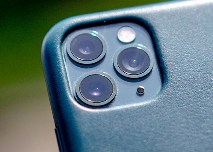 Close-up of a modern smartphone's triple camera system, used for taking photos, reflecting moments people asked celebrities for a photo.