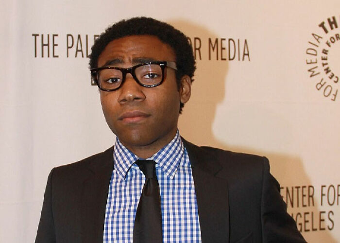 Donald Glover looking serious in a suit and glasses. One of the worst moments people asked celebrities for a photo.