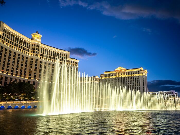 The Bellagio Fountains at night, a grand public spectacle, contrasting with scary, disturbing events.