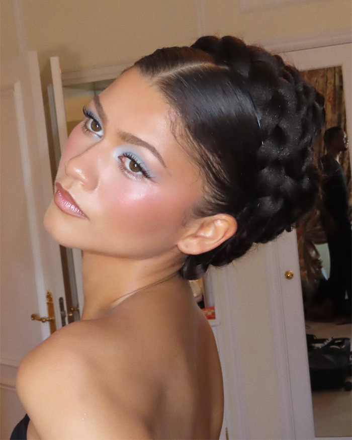 Zendaya's latest look features a intricate braided updo and elegant blue eye makeup, captured in a candid shot. Zendaya's latest look features a intricate braided updo and elegant blue eye makeup, captured in a candid shot.