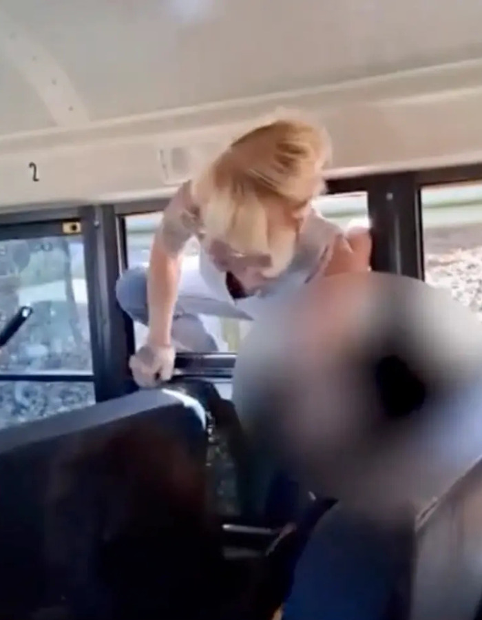 Furious parents smash their way into school bus after driver refuses to release kids, parent climbing through bus window. Furious parents smash their way into school bus after driver refuses to release kids, parent climbing through bus window.
