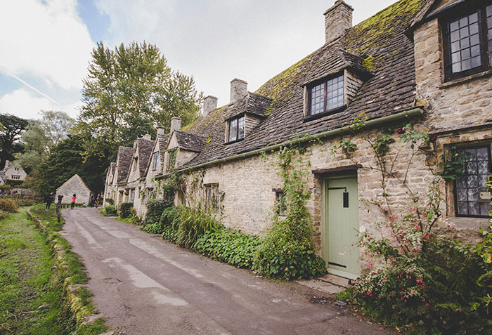 A row of old stone houses in the world's most beautiful village, attracting tourists with its charm. A row of old stone houses in the world's most beautiful village, attracting tourists with its charm.