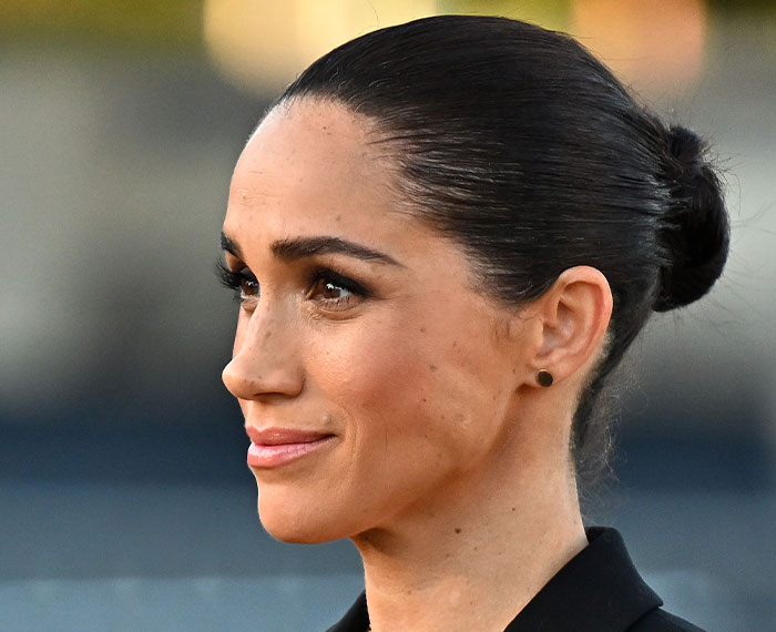 Meghan Markle with her hair neatly pulled back, looking to the side. Her acting comeback generated buzz and backlash.
