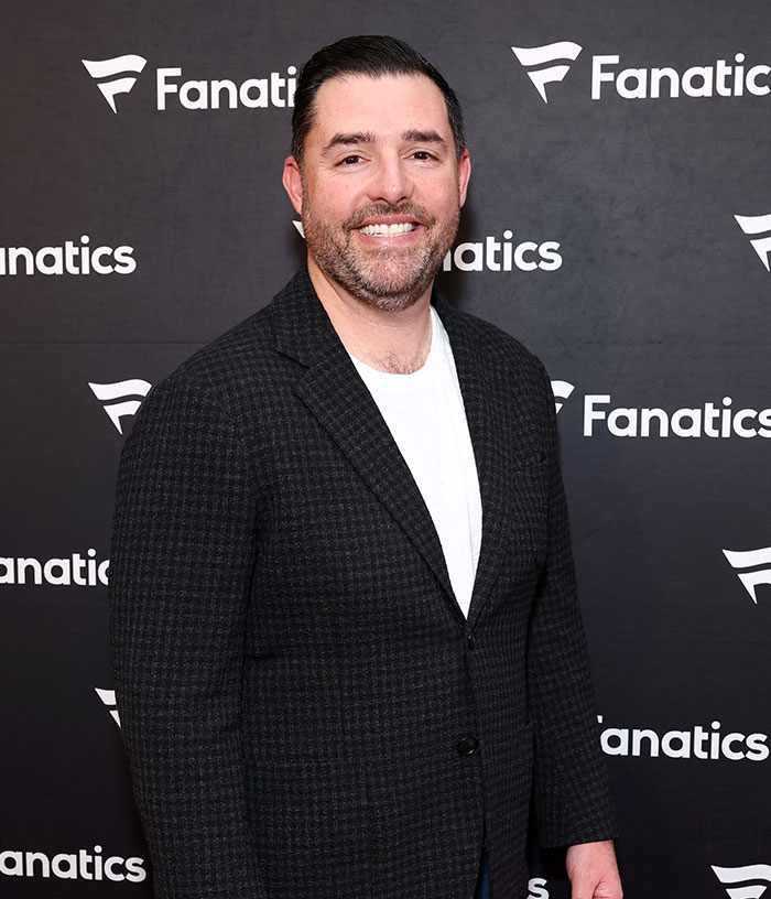 Jed York smiling for the camera with a Fanatics background, showing his involvement as 49ers owner.