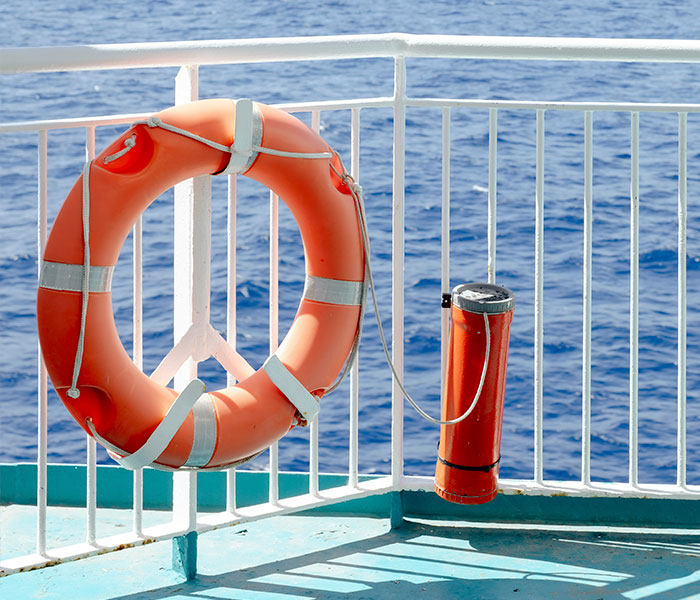 An orange life preserver on a Disney Cruise ship deck, symbolizing safety amidst the passenger incident.