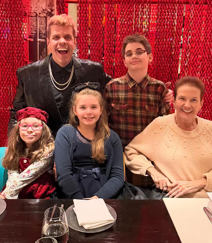 Perez Hilton and family posing at a restaurant, revealing a disturbing livestream and dark childhood secret.