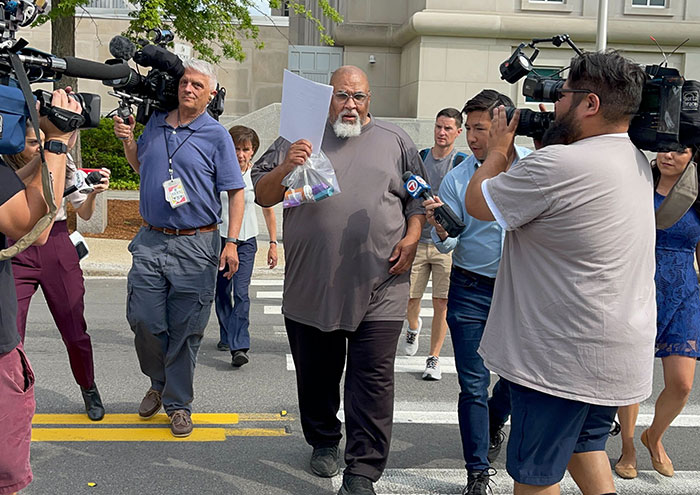 A man with a bag of evidence walking past reporters, exposing the truth about bodies donated to Harvard for science. A man with a bag of evidence walking past reporters, exposing the truth about bodies donated to Harvard for science.