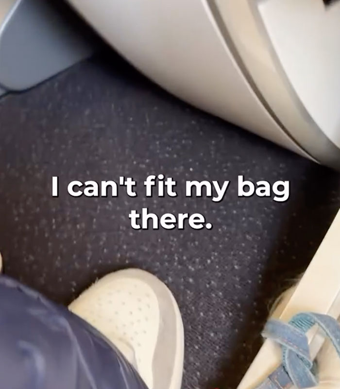 A passenger's feet on an airplane, highlighting the challenge for a wheelchair advocate to fit his bag. A passenger's feet on an airplane, highlighting the challenge for a wheelchair advocate to fit his bag.