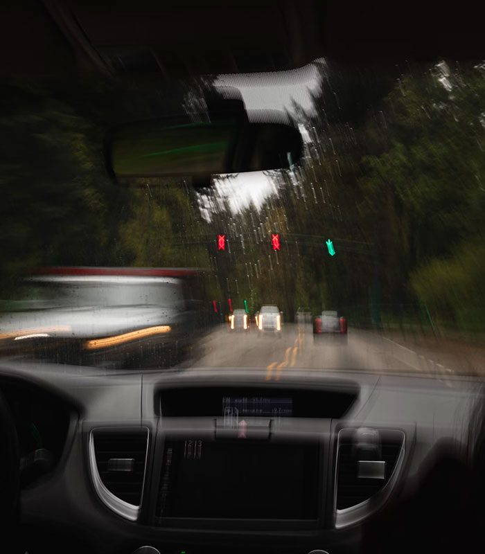 Blurry view from inside a car on a road, reflecting the disorienting car crash into a ditch.
