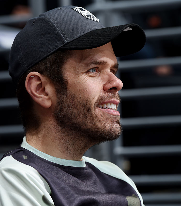 Perez Hilton in a baseball cap, smiling, as he faces disfigurement and recovery after a disturbing livestream. Perez Hilton in a baseball cap, smiling, as he faces disfigurement and recovery after a disturbing livestream.