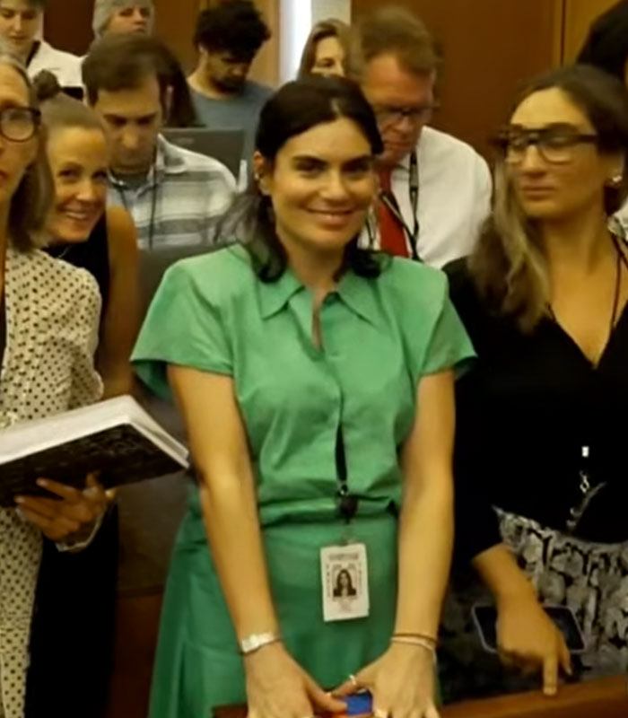 The green dress lady from the Lindsay Clancy trial smiles in court, sparking backlash after a viral video. The green dress lady from the Lindsay Clancy trial smiles in court, sparking backlash after a viral video.