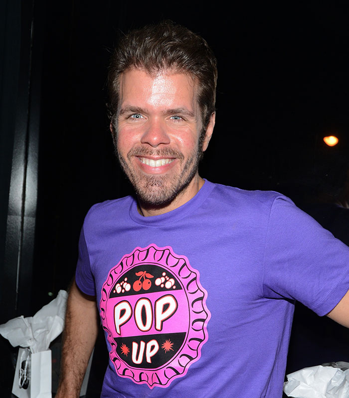 Perez Hilton in a purple t-shirt, smiling, amidst his recovery from disfigurement after a disturbing livestream. Perez Hilton in a purple t-shirt, smiling, amidst his recovery from disfigurement after a disturbing livestream.