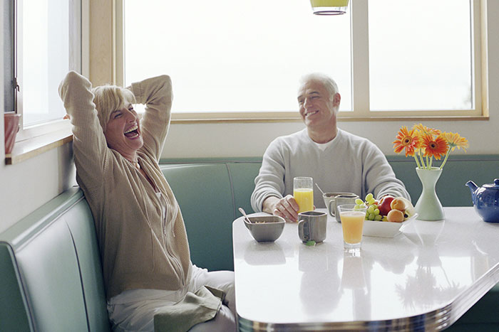 Happy couple enjoying a common breakfast habit, linked to higher mortality risk, especially after age 40. Happy couple enjoying a common breakfast habit, linked to higher mortality risk, especially after age 40.