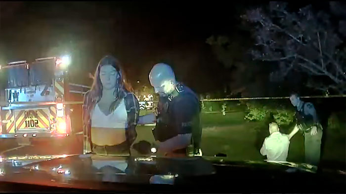 Police arrest a woman at night near a fire truck after she took a bride's life on her wedding day. Police arrest a woman at night near a fire truck after she took a bride's life on her wedding day.