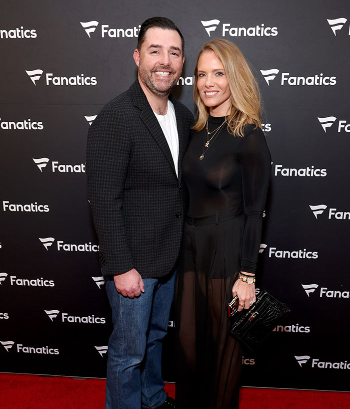 Jed York with his partner against a Fanatics backdrop, highlighting the 49ers owner's presence at events.