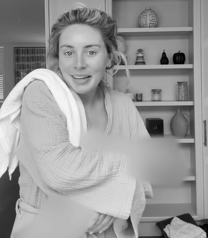 Bonnie Blue, in a bathrobe, poses at home, her expression showing surprise after giving birth to a healthy baby. Bonnie Blue, in a bathrobe, poses at home, her expression showing surprise after giving birth to a healthy baby.