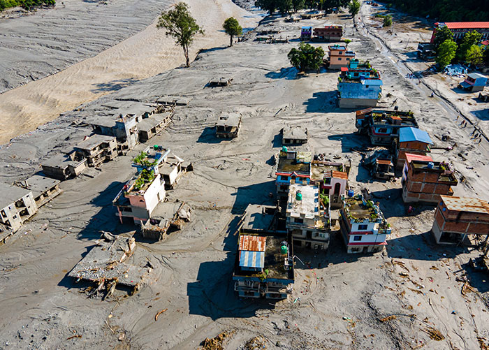 An aerial view of a village submerged in mud after the Nepal floods, highlighting the devastation. An aerial view of a village submerged in mud after the Nepal floods, highlighting the devastation.
