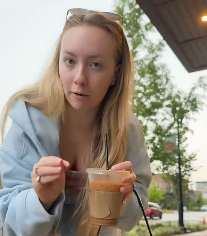 Influencer filming a video with an iced coffee outdoors, calling out Venetians for their reaction. Influencer filming a video with an iced coffee outdoors, calling out Venetians for their reaction.
