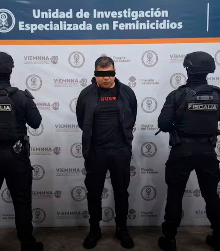 A man with a blindfold, flanked by two officers, related to the beauty influencer and cartel boss assassination. A man with a blindfold, flanked by two officers, related to the beauty influencer and cartel boss assassination.
