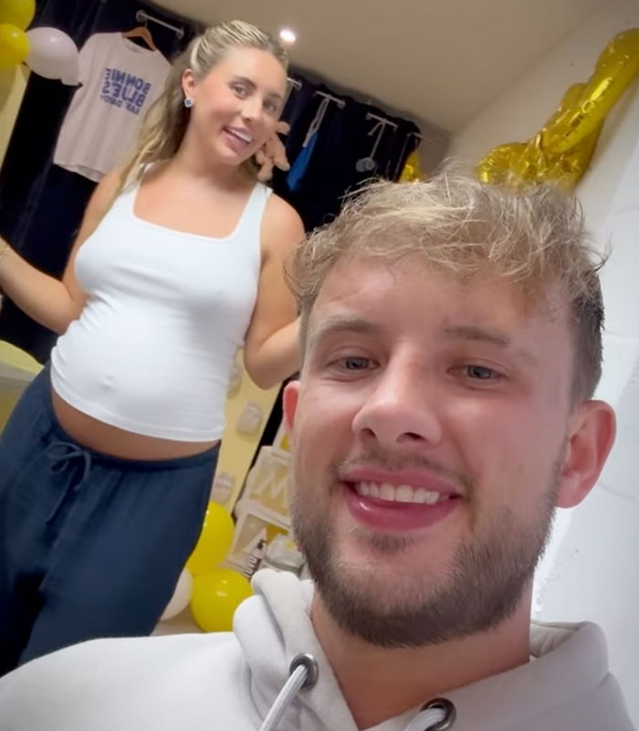 Man smiles in a selfie with pregnant Bonnie Blue at her raunchy baby shower.