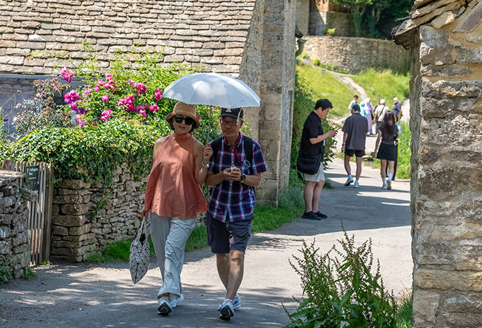 Tourists stroll through the world's most beautiful village, an unusual strategy attracting visitors. Tourists stroll through the world's most beautiful village, an unusual strategy attracting visitors.