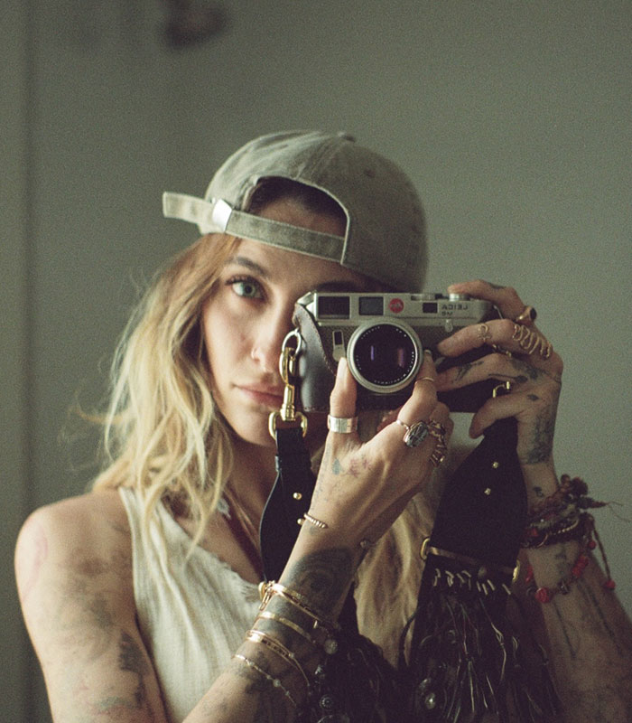 Paris Jackson holding a camera, reflecting on life with Michael Jackson and his disturbing accusations. Paris Jackson holding a camera, reflecting on life with Michael Jackson and his disturbing accusations.