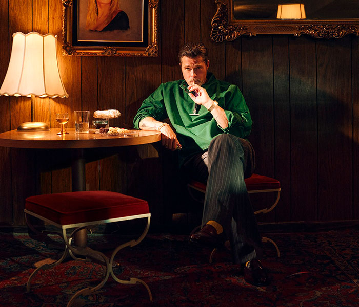 Brad Pitt drinking: Actor seated at a table, holding a cigarette, with a drink nearby. Brad Pitt's sobriety. Brad Pitt drinking: Actor seated at a table, holding a cigarette, with a drink nearby. Brad Pitt's sobriety.