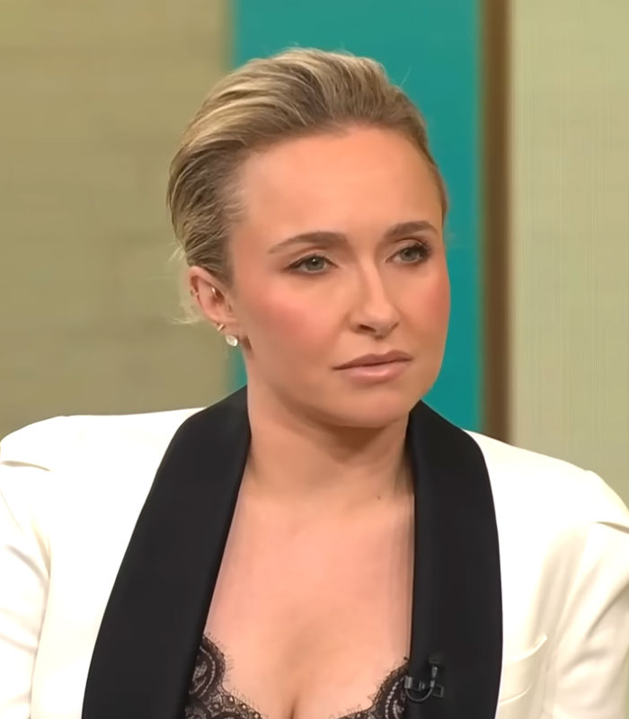 Hayden Panettiere with a serious expression, wearing a white blazer with black lapels, discussing autopsy results. Hayden Panettiere with a serious expression, wearing a white blazer with black lapels, discussing autopsy results.