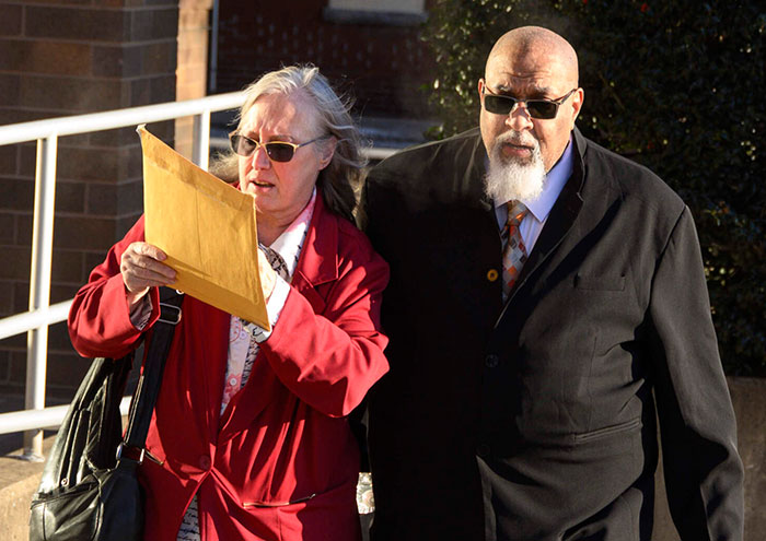 A man and a woman, possibly family members, walking outside after learning about donated bodies. A man and a woman, possibly family members, walking outside after learning about donated bodies.