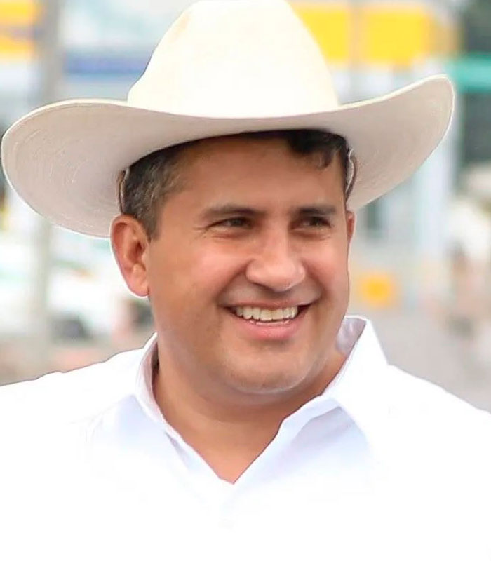 A smiling man wearing a white hat, allegedly a cartel boss who had a beauty influencer assassinated during a livestream. A smiling man wearing a white hat, allegedly a cartel boss who had a beauty influencer assassinated during a livestream.