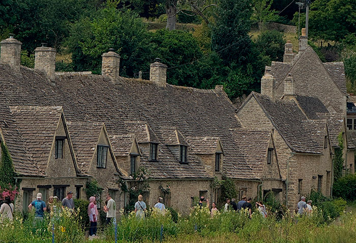 Rows of historic stone cottages in the world's most beautiful village, drawing many tourists. Rows of historic stone cottages in the world's most beautiful village, drawing many tourists.