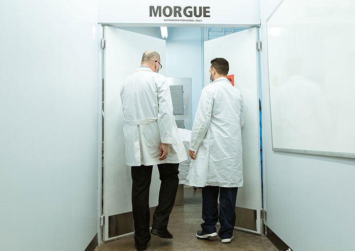 Two doctors in white coats entering a morgue, where donated bodies for science were mishandled at Harvard. Two doctors in white coats entering a morgue, where donated bodies for science were mishandled at Harvard.