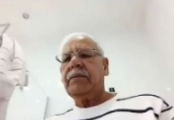 Man on a video call, part of the politician's livestreamed meeting background scandal. Man on a video call, part of the politician's livestreamed meeting background scandal.