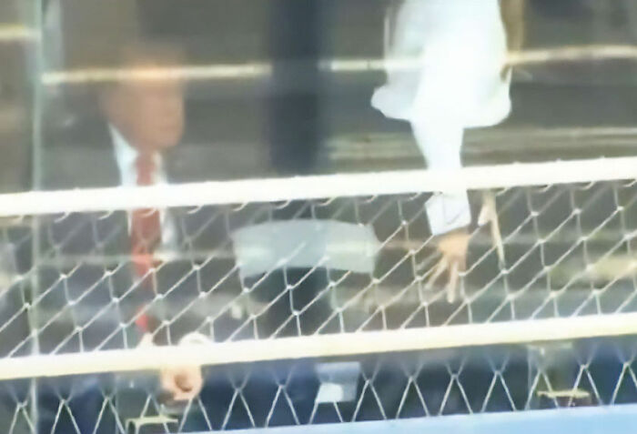A blurred image showing Melania and Donald Trump at IndyCar Event with the main SEO keyword 'Lip Reader Decodes Heated Exchange'. A blurred image showing Melania and Donald Trump at IndyCar Event with the main SEO keyword 'Lip Reader Decodes Heated Exchange'.