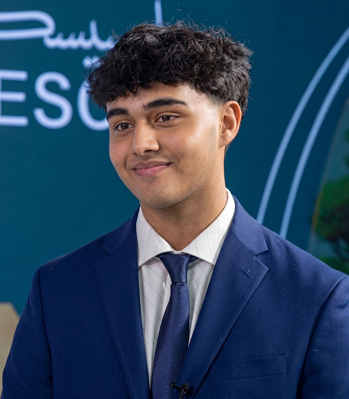 Florida teenager, Aakash Manaswi, who invented a bee-saving device, smiling in a blue suit. Florida teenager, Aakash Manaswi, who invented a bee-saving device, smiling in a blue suit.