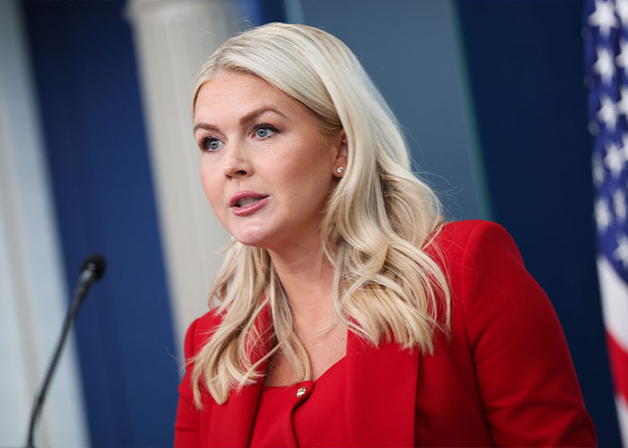 Karoline Leavitt as Press Secretary at a podium, speaking, amidst scrutiny of her sudden exit.
