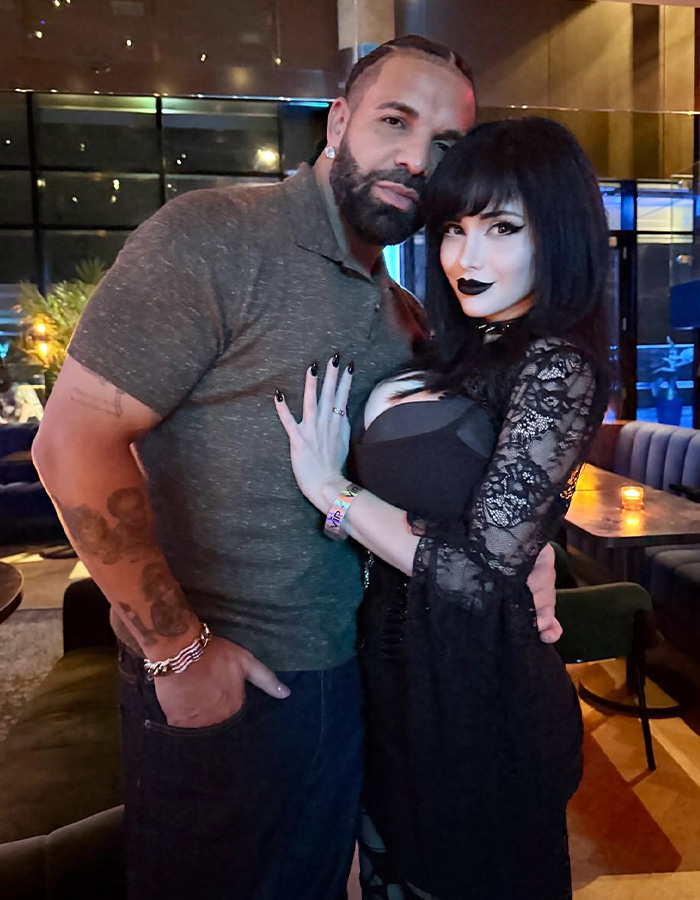 Drake and Goth Baddie posing together at a dating show encounter. Drake and Goth Baddie posing together at a dating show encounter.