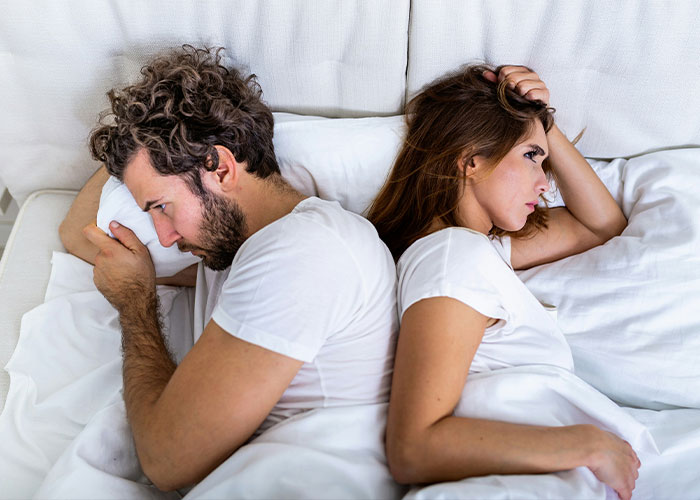 A couple in bed with backs to each other, illustrating how the 72-hour rule could be dividing couples. A couple in bed with backs to each other, illustrating how the 72-hour rule could be dividing couples.