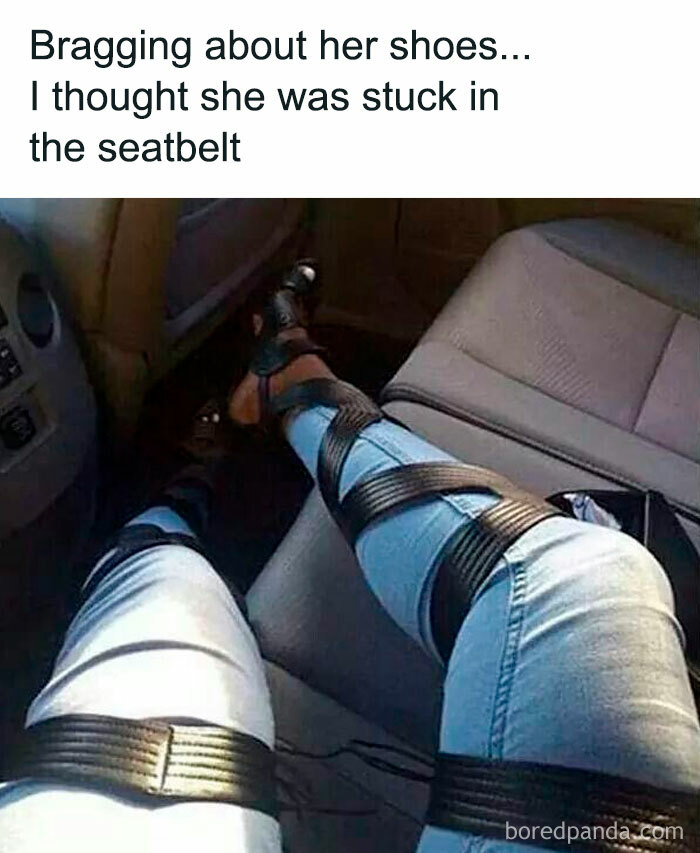 A person's legs in light-wash jeans, appearing to be tightly wrapped with black straps in a car seat, a hilariously bad fashion crime.