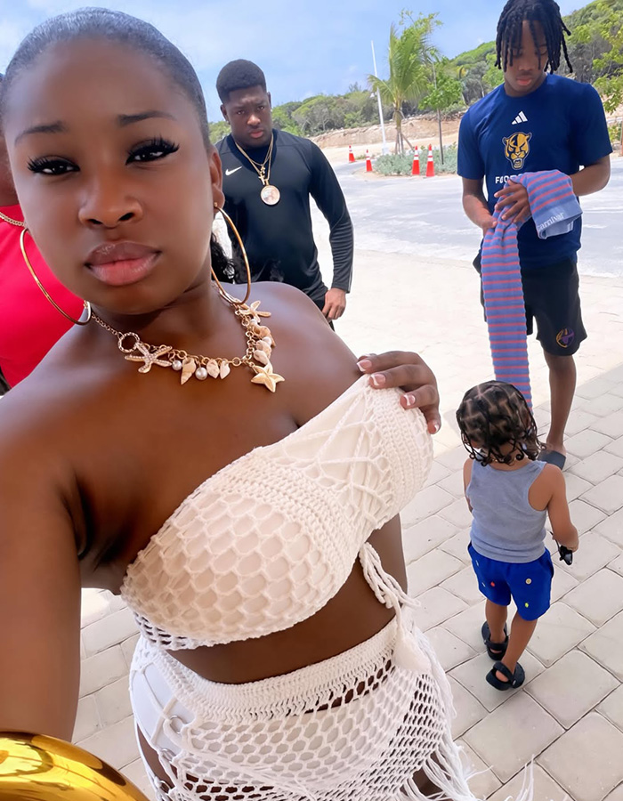 A woman in a white crochet top poses for a selfie, with a man and a child in the background. The 'baby canceled' post went viral due to a woman's decision over a problematic father. A woman in a white crochet top poses for a selfie, with a man and a child in the background. The 'baby canceled' post went viral due to a woman's decision over a problematic father.