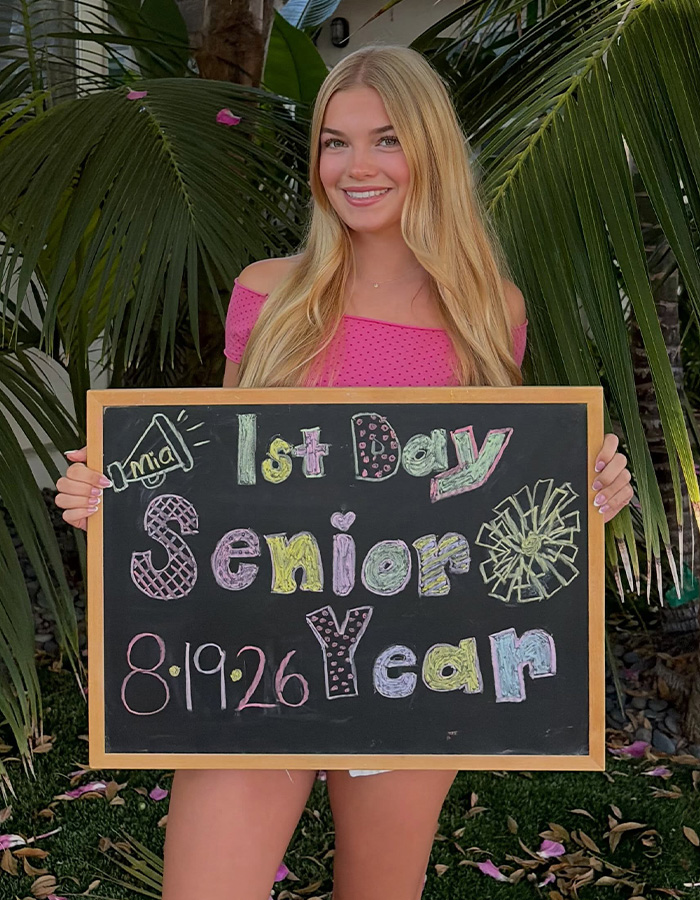 Child star from Disney's Good Luck Charlie, Mia Talerico, holding a '1st Day Senior Year' sign, looking unrecognizable. Child star from Disney's Good Luck Charlie, Mia Talerico, holding a '1st Day Senior Year' sign, looking unrecognizable.
