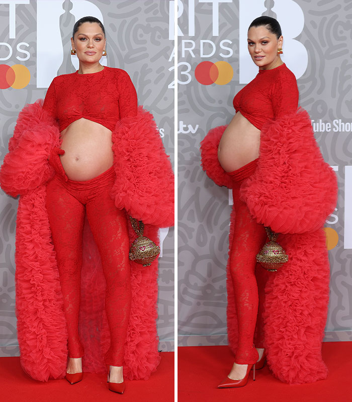 Jessie J in a vibrant red celebrity pregnancy outfit with a ruffled coat, embracing a daring fashion statement.
