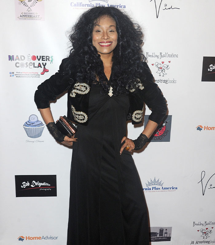 Nickelodeon star Christy Knowings at a red carpet event, posing in a black dress with an embroidered jacket. Nickelodeon star Christy Knowings at a red carpet event, posing in a black dress with an embroidered jacket.
