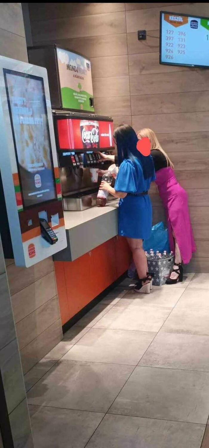 Women refilling drinks in a fast-food restaurant in Eastern Europe, demonstrating why people are built different.