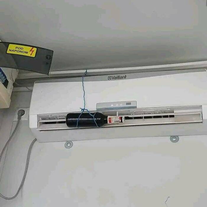 A wine bottle cooling in an air conditioner, a resourceful way showing Eastern Europe are built different.